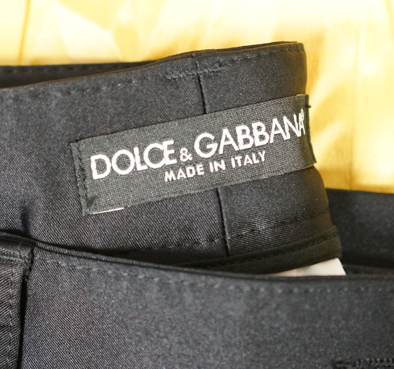 A lady's Dolce & Gabbana yellow silk blouse and a pair of black satin jeans. Blouse size 44 Trousers size 42